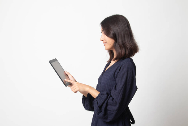 Young Asian woman with a computer tablet on white background - Foto, imagen