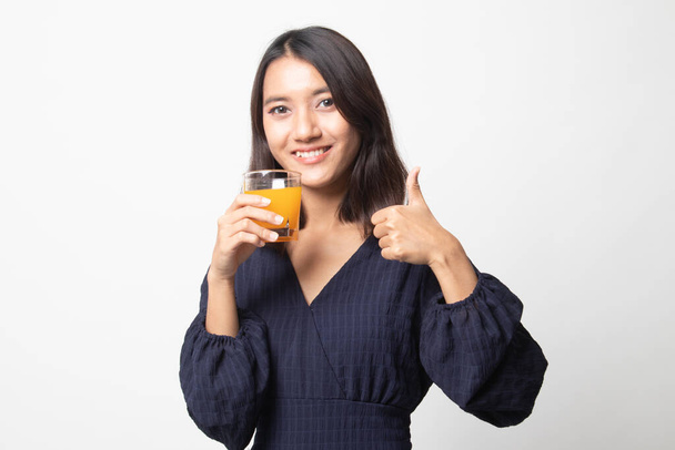Young Asian woman thumbs up drink orange juice on white background - Zdjęcie, obraz