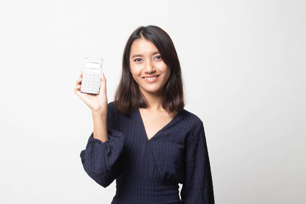 Asian woman smile with calculator on white background - Zdjęcie, obraz