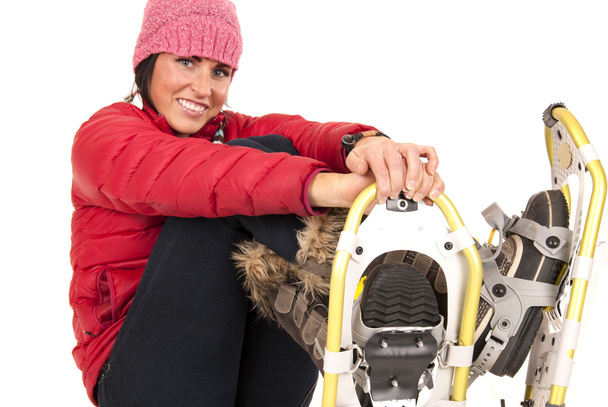 Happy female model sitting down in snow shoes - Фото, зображення