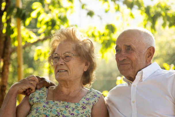 senior couple holding each other in the field outdoors - Photo, Image