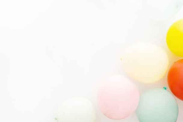 A top view of colorful balloons on a white background - Photo, image