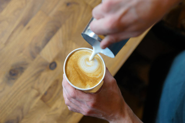Barista prepares coffee in a paper cup - Photo, Image