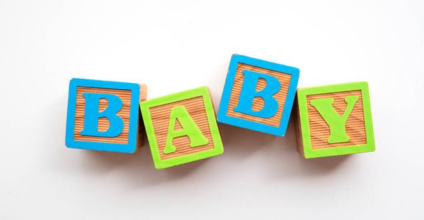 Baby word made from colourful wooden baby development blocks - Zdjęcie, obraz
