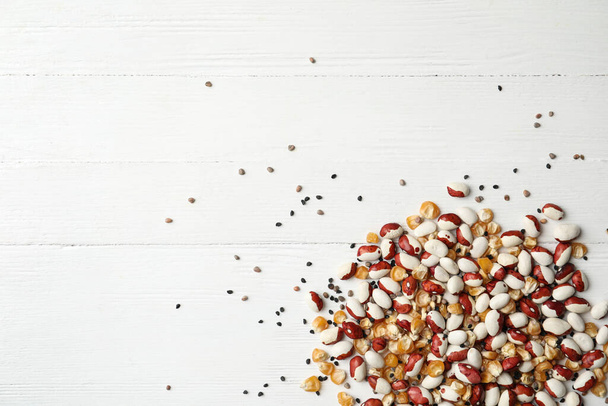 Mixed vegetable seeds on white wooden background, flat lay - Foto, immagini