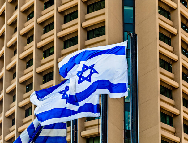 Israel flags on background of building in Tel Aviv Magen David sign, Israel independence day, David's star - Фото, изображение