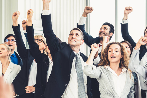 Successful business people standing together showing strong relationship of worker community. A team of businessman and businesswoman expressing a strong group teamwork at the modern office. - Photo, Image