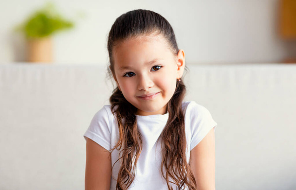 Little Asian Girls Portrait, Kid Sitting On Sofa At Home - Photo, Image