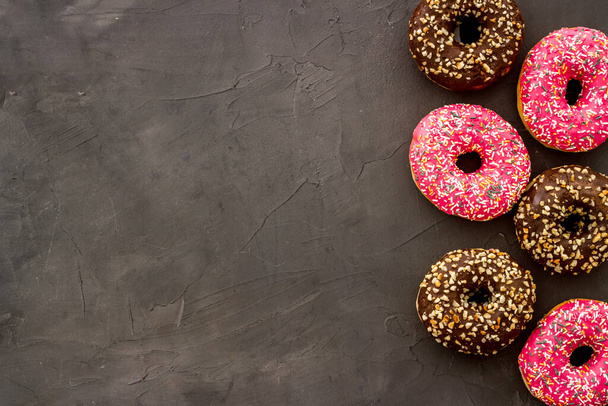 Top view of colorful glazed donut swith sprinkles, copy space - 写真・画像