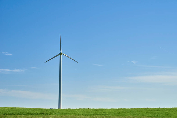 Wind turbine in the field. Wind power energy concept. Renewable energy for climate protection - Photo, Image