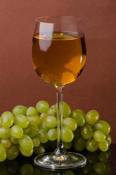 Ποτήρι με λευκό κρασί και σταφύλια. Νεκρή ζωή - Φωτογραφία, εικόνα