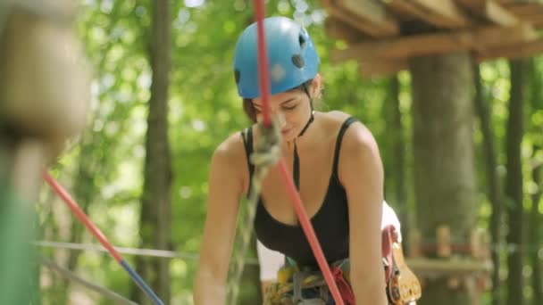 Adventure climbing high wire park - osoby na kursie w hełmie górskim i sprzęcie bezpieczeństwa - Materiał filmowy, wideo
