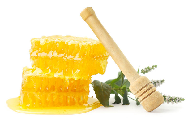 Honeycomb and honey stick close-up on a white background. Isolated - Photo, Image