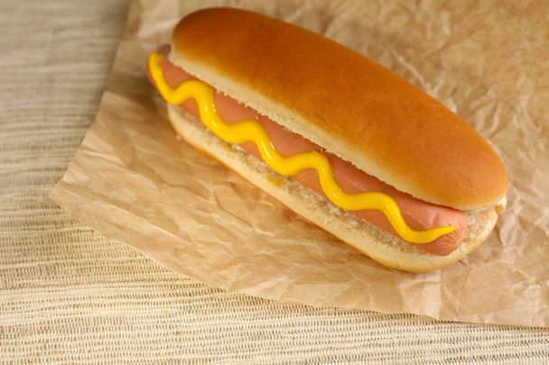 Tasty hot dog on paper - 写真・画像