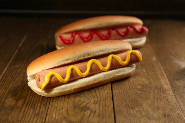 Tasty hot dogs on wooden table - Zdjęcie, obraz