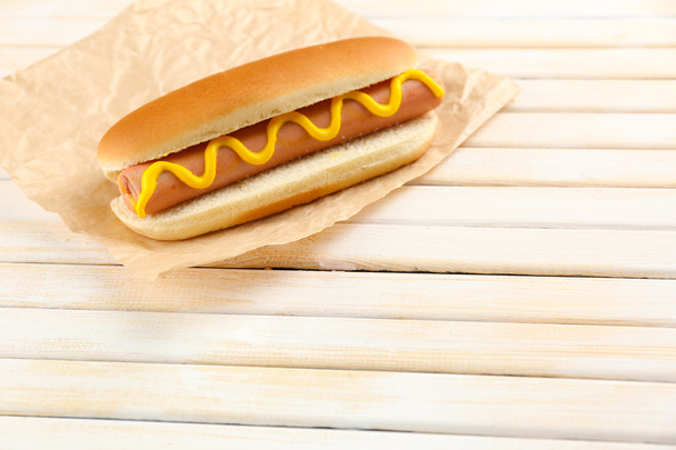 Tasty hot dog on wooden table - Fotografie, Obrázek