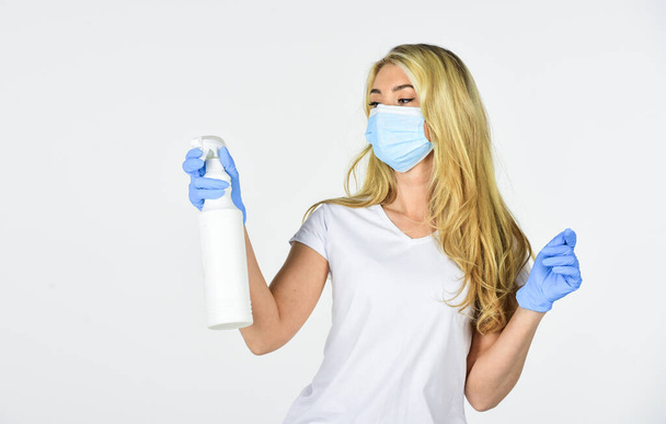 woman in respirator mask use hand sanitizer. girl in rubber gloves spray with cleaner detergent. precautions for coronavirus. covid-19 pandemic quarantine. disinfector or antiseptic. care your health - Фото, изображение