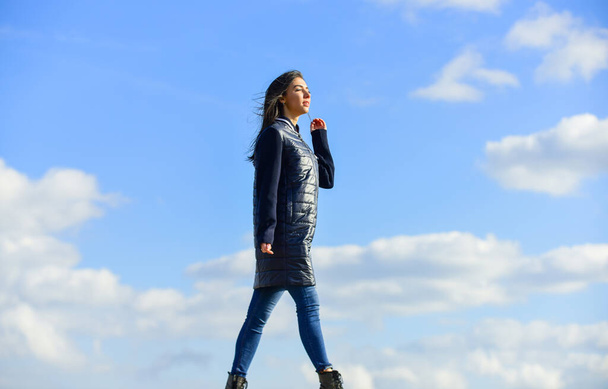 Dreamy girl. Young and free concept. Expect more from your clothes. Woman enjoy weather outdoors. Beauty and fashion. Walking alone. Woman on blue sky background. Winter vacation. Long jacket coat - Photo, image