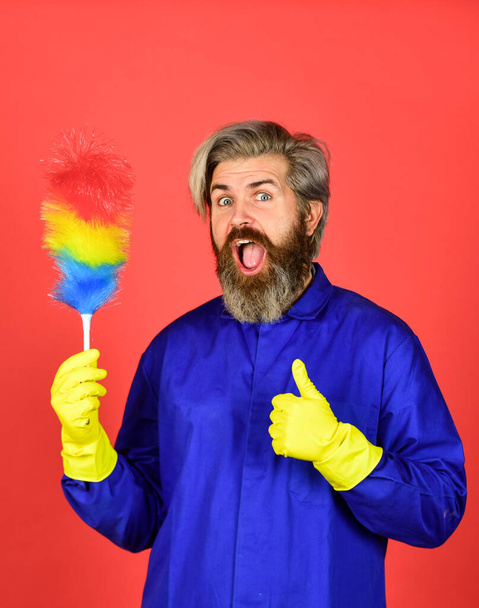 Gender inequality. man use pp duster. hipster holding the cleaning tool. clean and home concept. Male Sweeping with small duster broom. cleaning service. housekeeping business. Cleaning the apartment - Фото, зображення