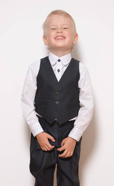Little fashionable boy posing on white background - Photo, image