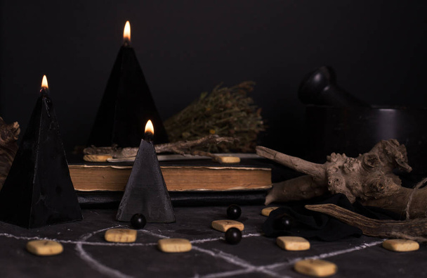 Still life with burning candles and pentagram circle background. Black magic ritual with occult, evil and esoteric symbols. Halloween or divination rite - Photo, Image