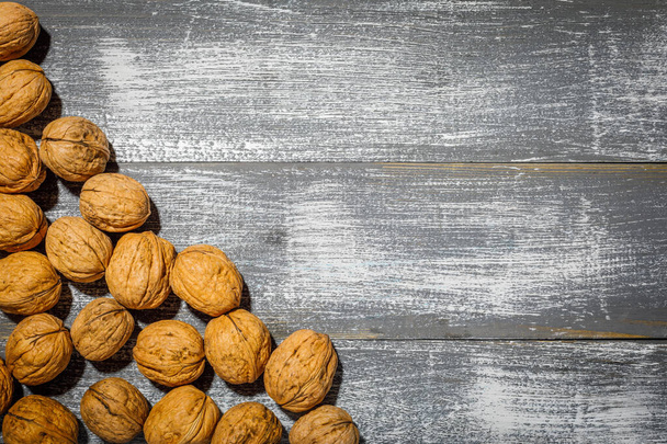 still life with walnuts on a wooden background - Fotoğraf, Görsel