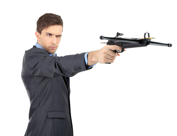 Young businessman with crossbow, isolated on white - Fotó, kép
