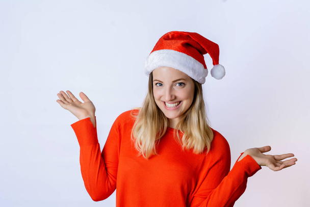 Portrait of young beautiful woman wearing christmas hat against white background on studio. Christmas and holiday concept. - Foto, Imagen