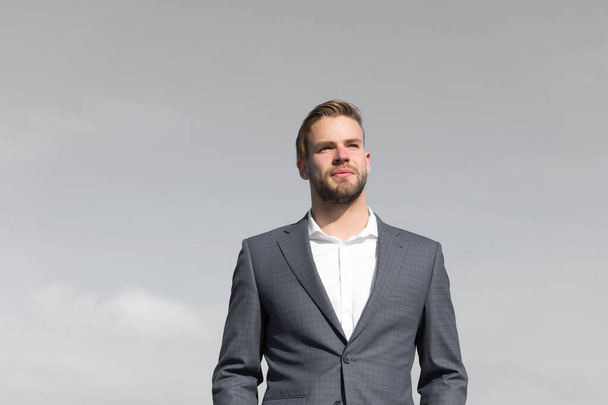 Businessman successful entrepreneur in suit walks outdoor sunny day, sky background. Man confident and well groomed enjoy freedom. Businessman attractive appearance looks successful. Freedom concept - Foto, immagini
