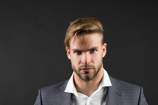 Feeling stressed after hard working day. Man bearded strict unhappy face looks untidy exhausted, dark background. Workaholic concept. Man unshaven guy looks stressed after stressful business meeting - Valokuva, kuva