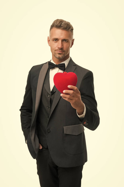 Generous man. Man mature handsome guy wear elegant suit hold red heart. Valentines day celebration. Romantic surprise. Celebrate valentines day. Prepare gift for valentine. Love date anniversary - Photo, image
