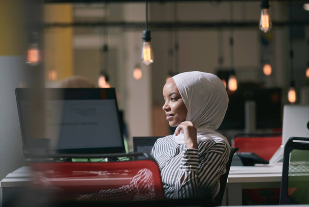 beautiful modern african Muslim businesswoman in office, wearing hijab at creative modern startup coworking space - Photo, image