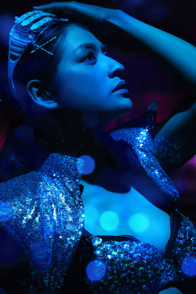 art portrait of woman model in fancy dress glowing in blue neon light - Фото, изображение