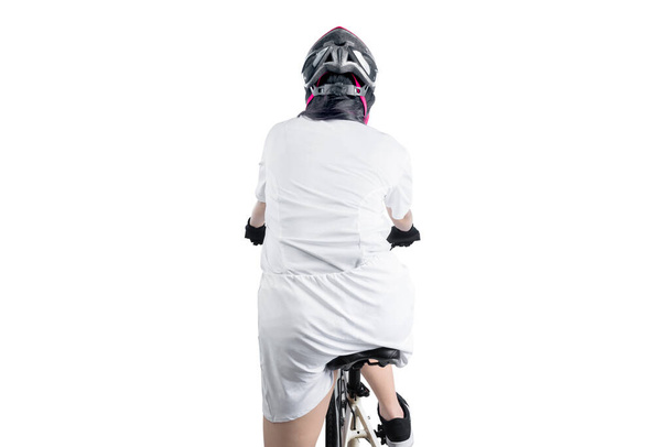 Rear view of Asian woman with a bicycle helmet riding a bicycle isolated over white background - Foto, afbeelding