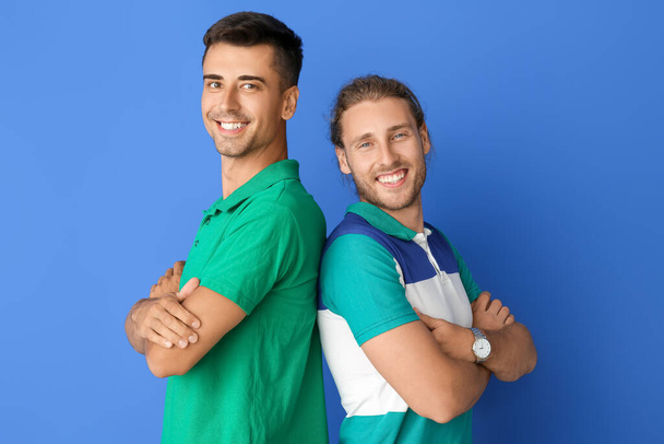Happy gay couple on color background - Foto, imagen