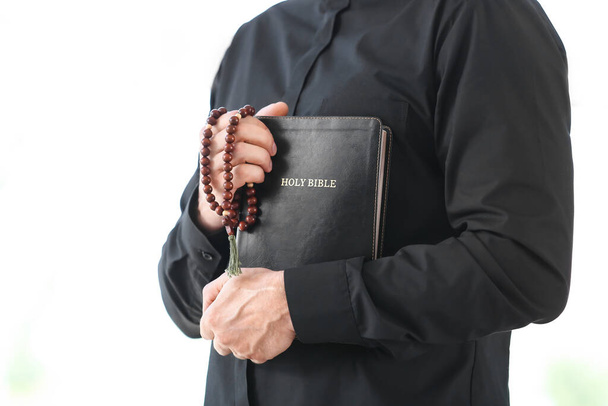 Male priest with Bible at home - Photo, Image