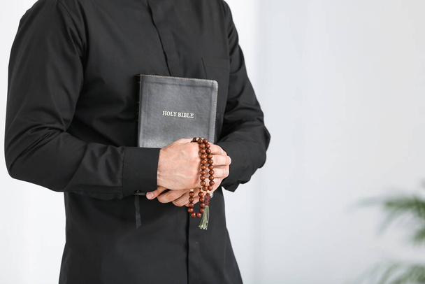 Male priest with Bible at home - Foto, Imagem