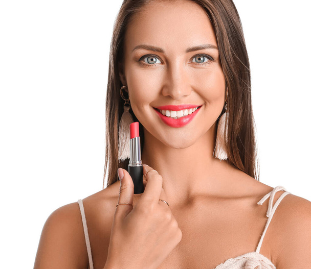 Beautiful young woman with lipstick on white background - Photo, Image