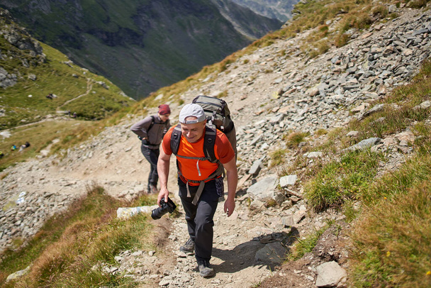 Family hiking into the mountains with backpacks - Foto, Imagem