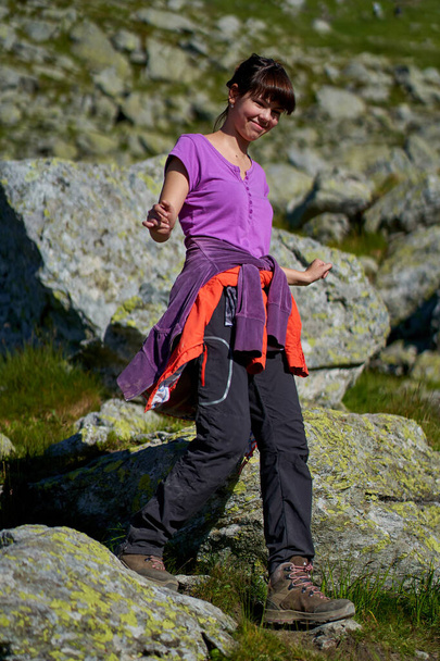 Young attractive girl hiking into the mountains - Фото, изображение