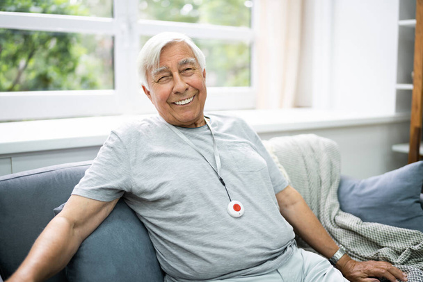 Happy Elderly Senior With Emergency Alarm Button - Foto, Imagen