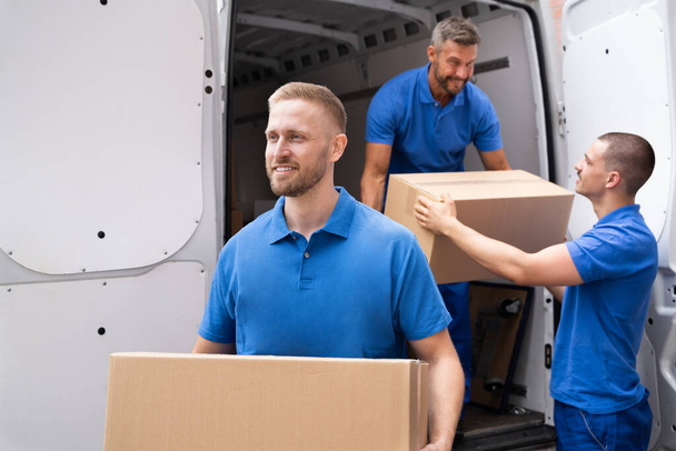 Truck Movers Loading Van Carrying Boxes And Moving House - Φωτογραφία, εικόνα