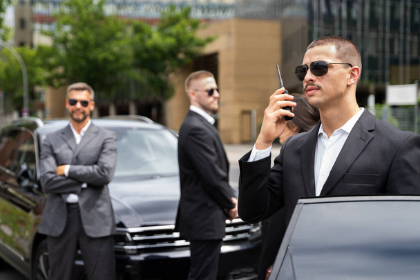 Business Security Guard Service At Work Near Luxury Car - Foto, imagen
