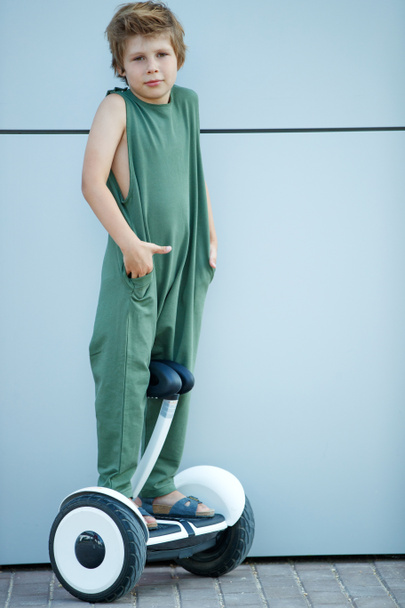 The child goes in for sports. A little boy is riding a hoverboard.  - Photo, image