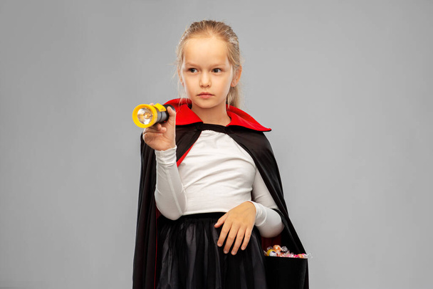 girl in halloween costume of dracula with candies - Foto, Imagem
