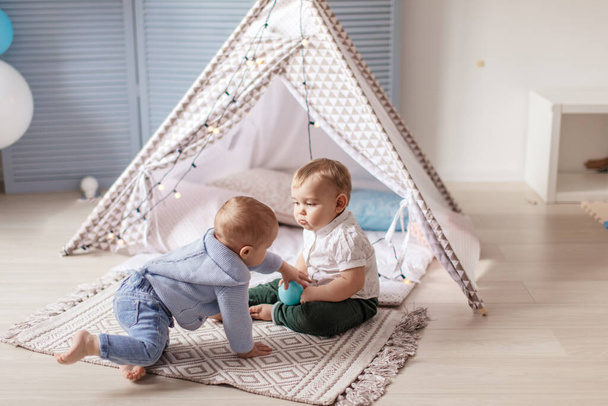 Couple male toddlers enjoying movement and simple games in cosy sunny nursery - Photo, image