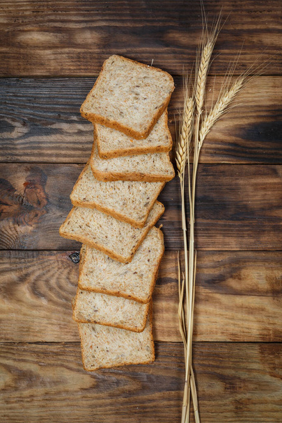 Sliced fresh gluten-free bread on wooden surface - Fotoğraf, Görsel