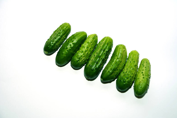 Fresh green cucumbers on white background - Foto, Imagen