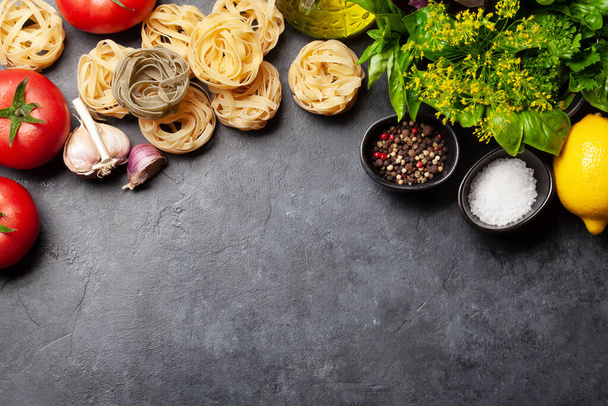 Italian cuisine ingredients. Garden tomatoes, pasta, herbs and spices. Top view with copy space. Flat lay - Φωτογραφία, εικόνα