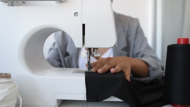 Young woman tailor is designing a new dress in her mini workshop. - Footage, Video